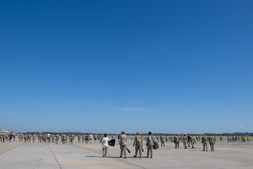 Hundreds of people walking on a flight line