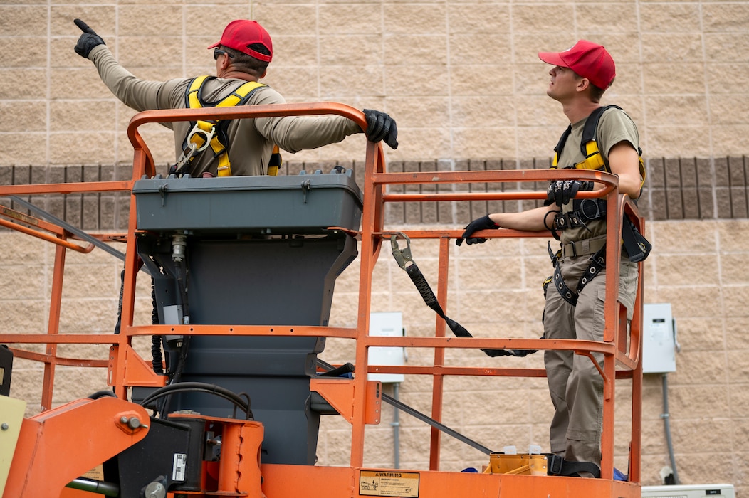 Two people on a mechanical lift