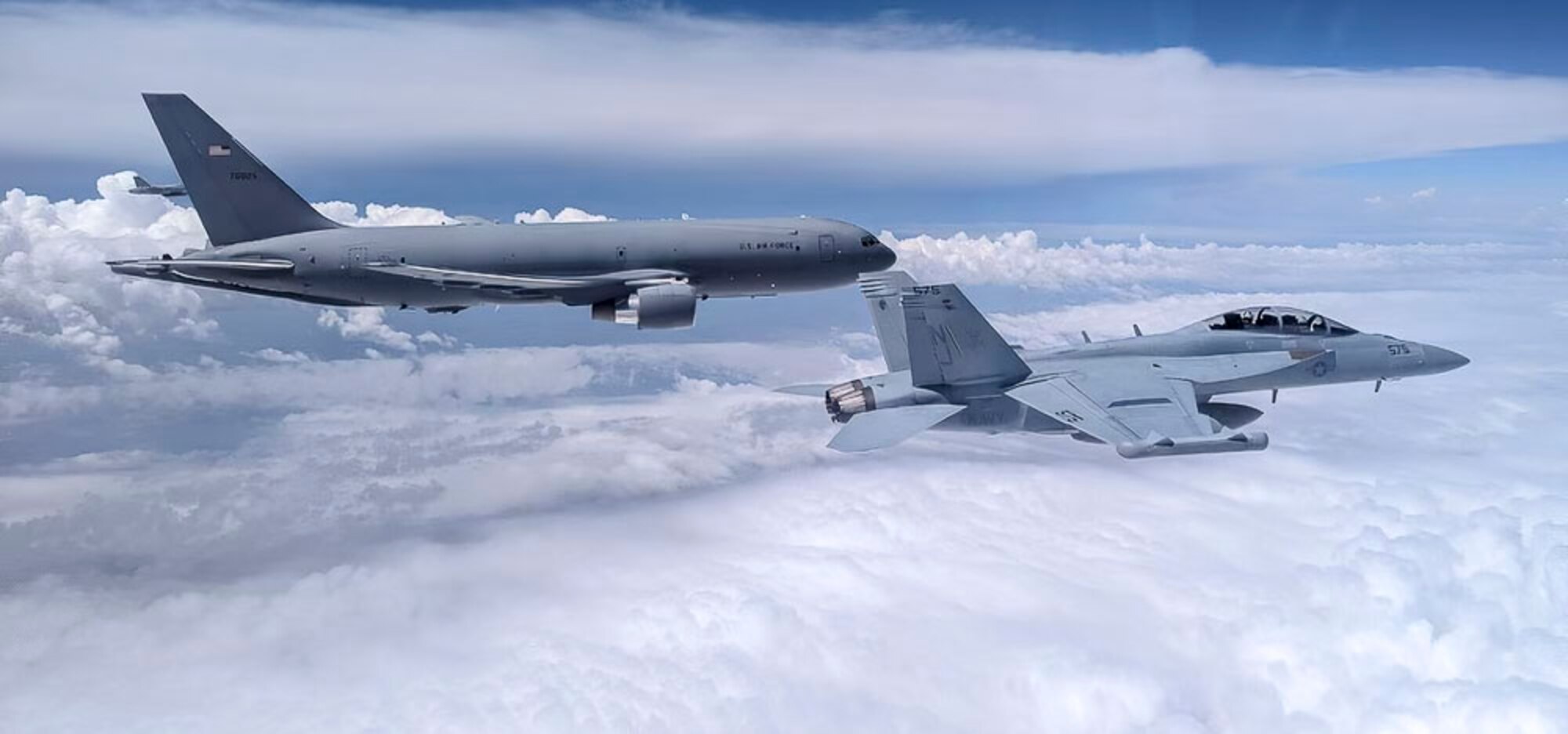 A U.S. Navy EA-18 Growler from Naval Air Station Whidbey Island, Washington, flies next to a U.S. Air Force KC-46A Pegasus from McConnell Air Force Base, Kansas, May 28, 2024, over the midwestern United States. The KC-46 refueled the Growlers on their way back to Washington. (Courtesy photo)