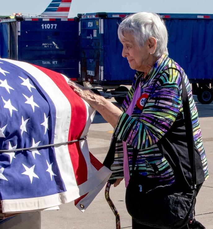 Rosemarie Dillon, of Batavia, the 89-year-old niece and primary next of kin of Illinois Army National Guard Pfc. Harry Jerele, touches his flag draped casket after it arrives at O’Hare International Airport, Chicago, Oct. 1.