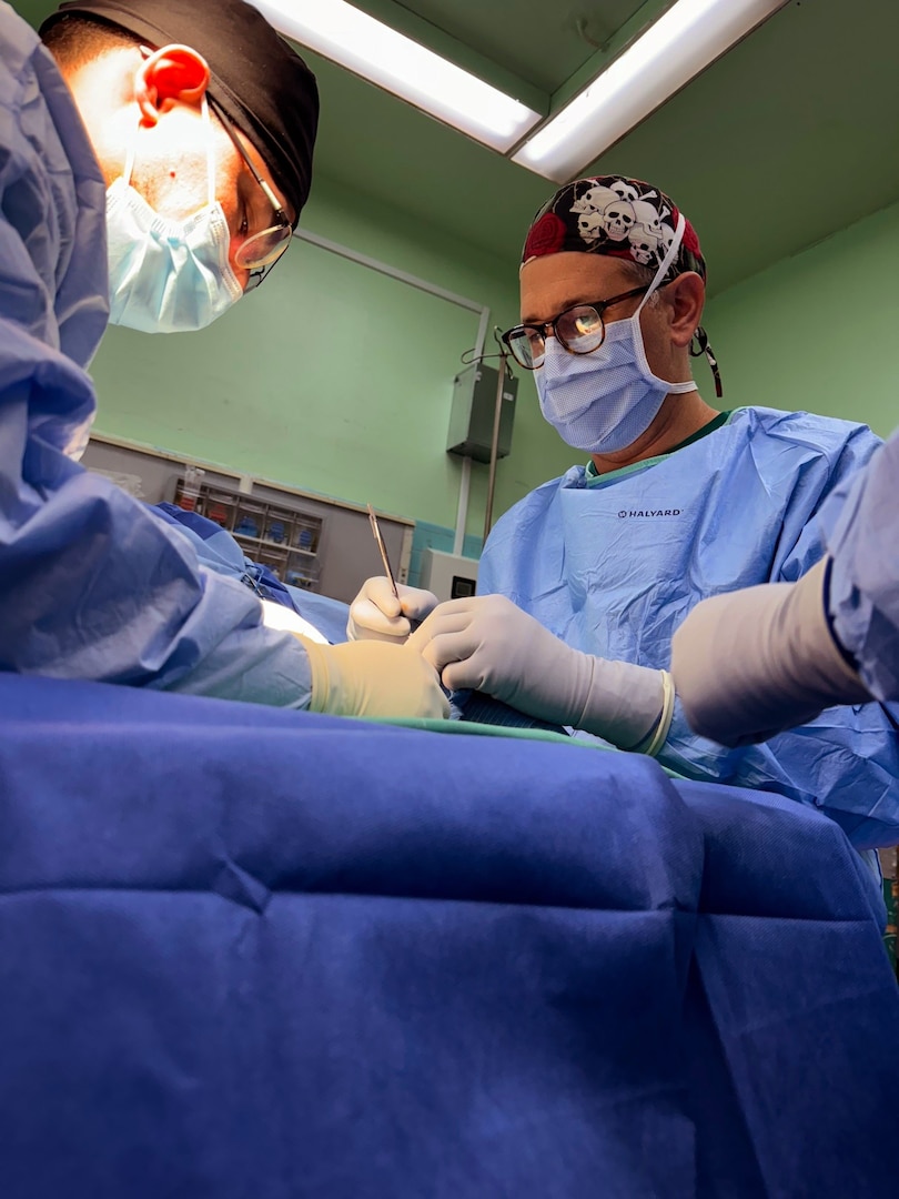 Cmdr. Louis Lewandowski (left front), an Expeditionary Medical Facility Kilo orthopedic trauma surgeon, works with Hospital Corpsman Second Class Brandon Cassidy (left back) and Honduran orthopedic residents to place a femoral external fixator on a trauma patient in the operating room at Hospital Escuela, Tegucigalpa, Honduras, Sep. 17, 2024. In collaboration with joint forces and the partner nation, EMF Kilo conducted its first orthopedic surgical mission alongside Hospital Escuela medical staff treating and performing surgical procedures on patients with oncologic or orthopedic traumatic injuries. (U.S. Navy photo by Lt. Cmdr. Sheree Blackwell)