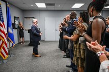 Mayor Shepherd stands in front of an applauding audience.