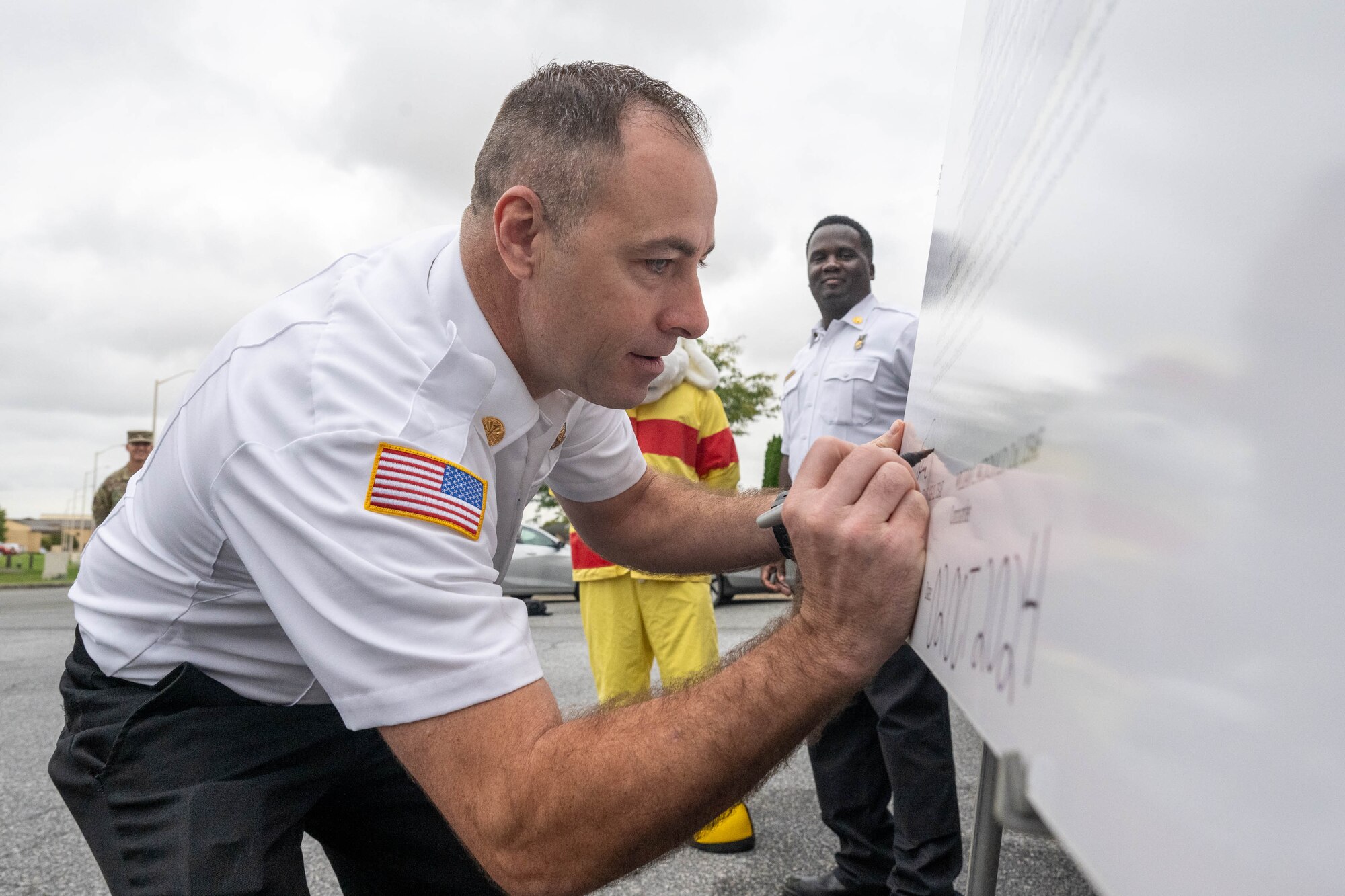 Thomas Krass, 436th Civil Engineer Squadron fire chief, signs the 2024 Fire Prevention Week proclamation, at Dover Air Force Base, Delaware, Oct. 2, 2024. First observed in 1925, Fire Prevention Week is the longest running public health observance in the United States. (U.S. Air Force photo by Mauricio Campino)