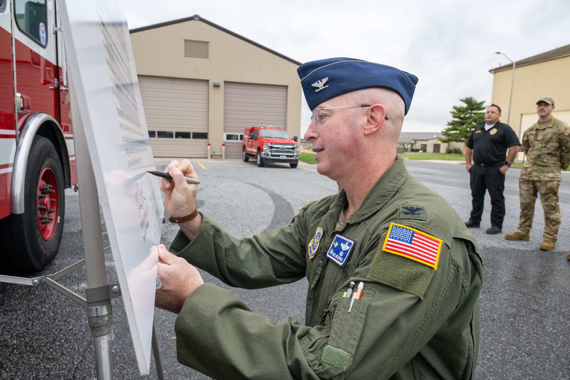 U.S. Air Force Col. Chris McDonald, 436th Airlift Wing commander, signs the 2024 Fire Prevention Week proclamation, at Dover Air Force Base, Delaware, Oct. 2, 2024. During Fire Prevention Week, the Dover AFB Fire Department hosts various activities to raise fire safety awareness for Airmen and their families. (U.S. Air Force photo by Mauricio Campino)
