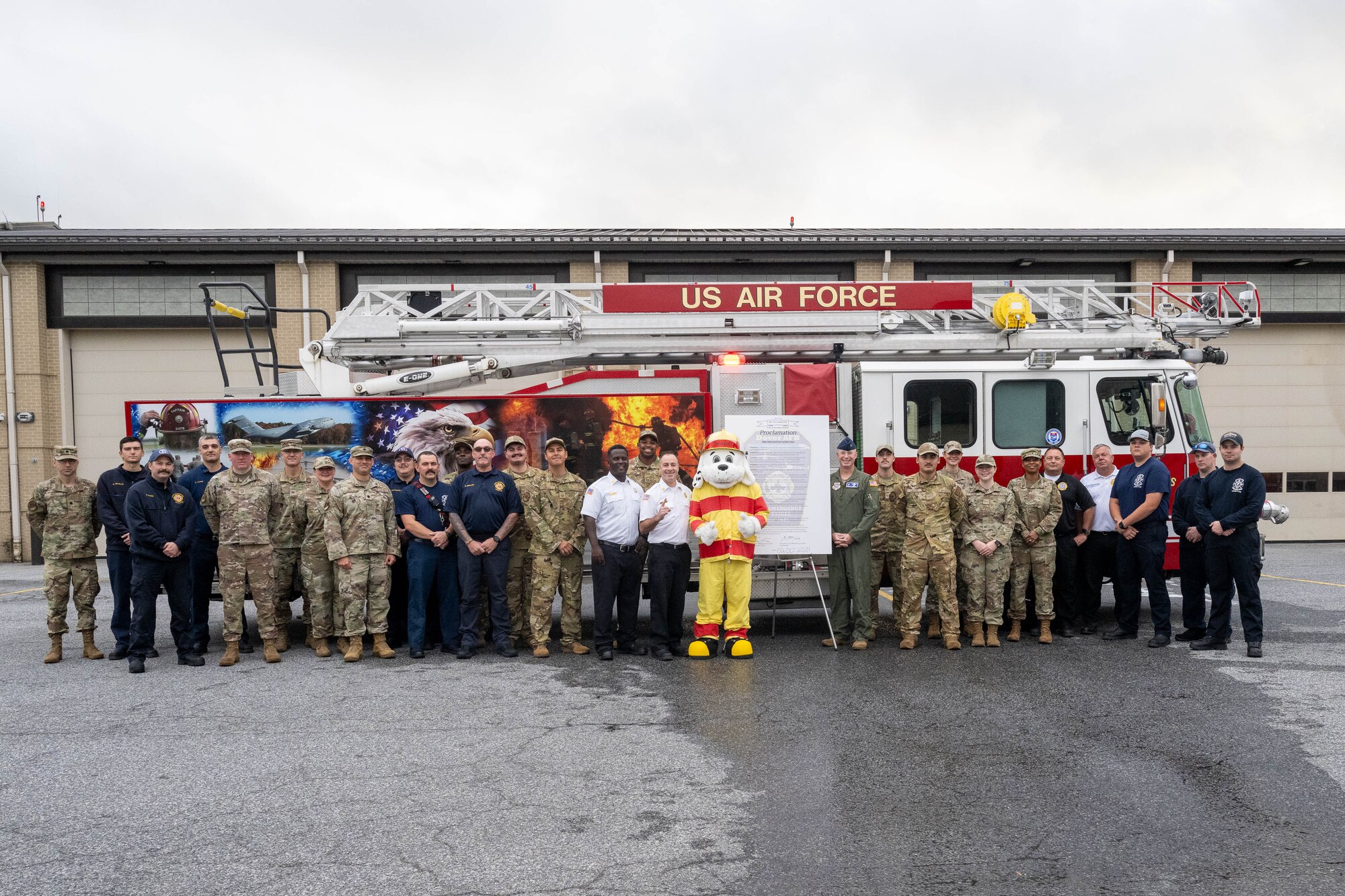 Dover Air Force Base leadership stand with 436th Civil Engineer Squadron Airmen, firefighters and the signed 2024 Fire Prevention Week proclamation at Dover AFB, Delaware, Oct. 2, 2024. During Fire Prevention Week, the 436th CES firefighters provide the Dover community with lifesaving education in an effort to decrease fire safety hazards. (U.S. Air Force photo by Mauricio Campino)