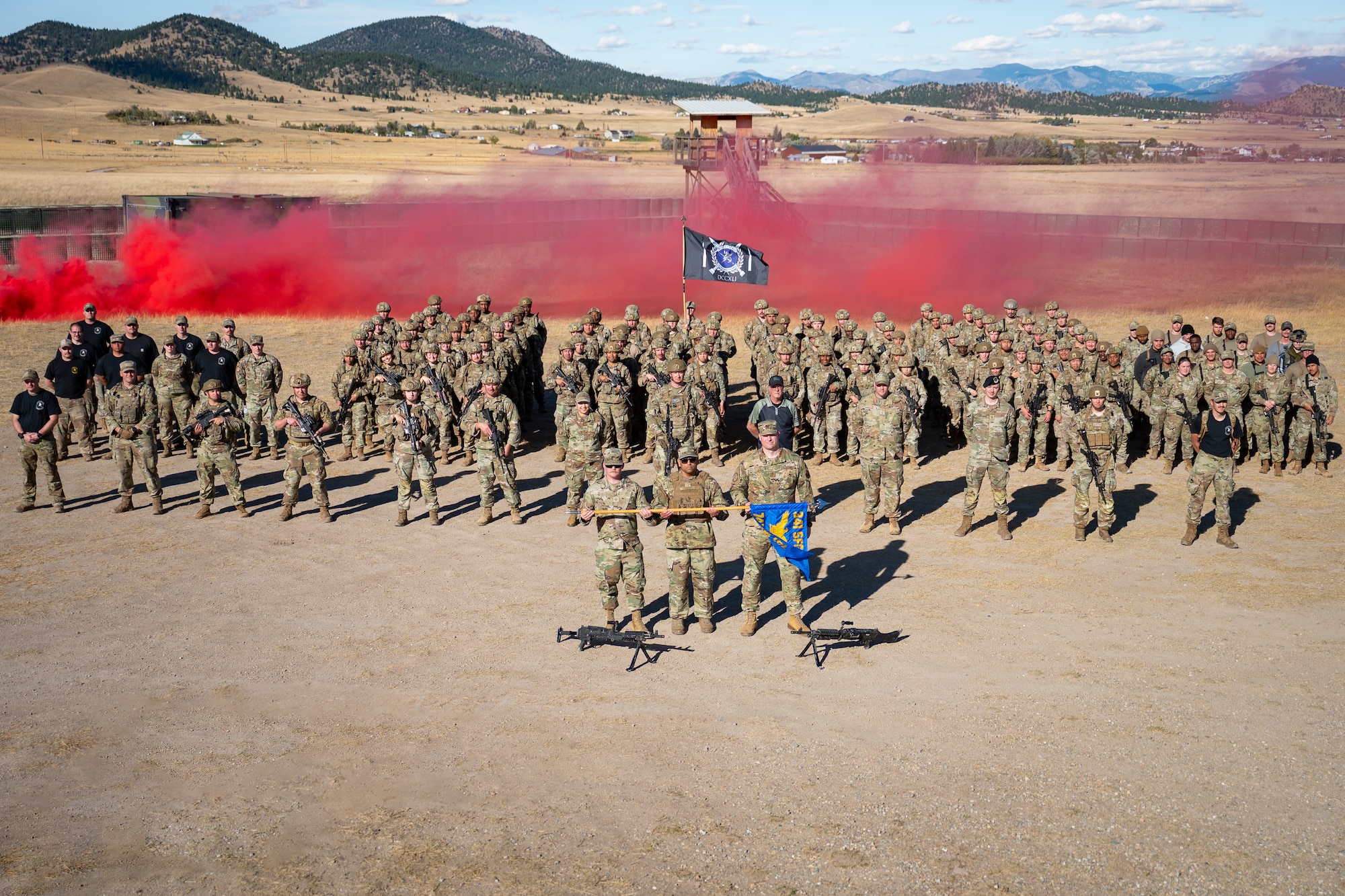 A group of uniformed personnel stand together.