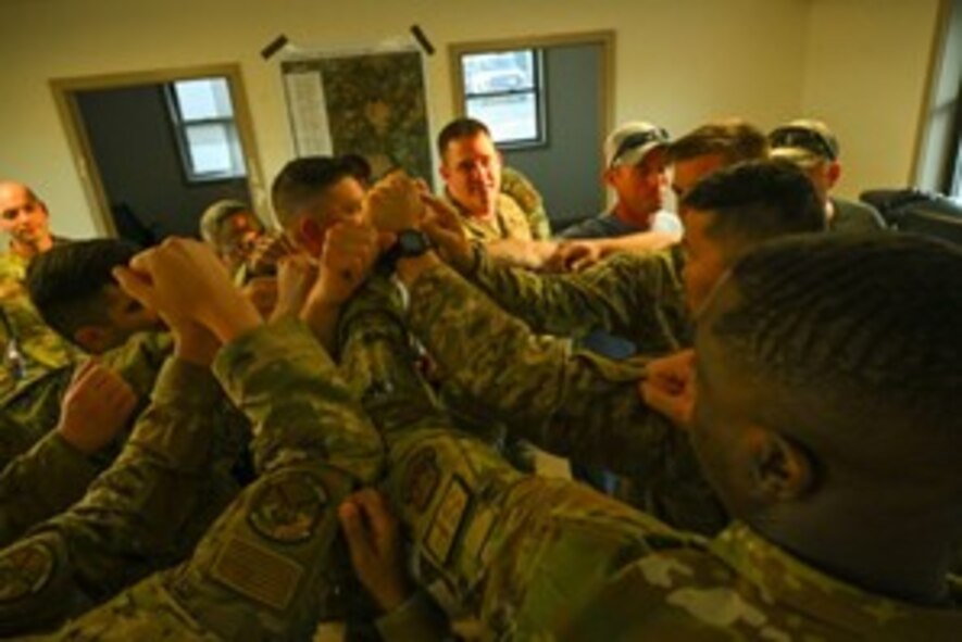 Leadership assigned to the 891st Missile Security Forces Squadron (MSFS) huddle up in preparation for Operation Cerberus at Camp Ripley, Minnesota, Sept. 22, 2024. Operation Cerberus was a readiness exercise designed to simulate a deployed environment and give an opportunity for Airmen of 891 MSFS to test their expeditionary skills.