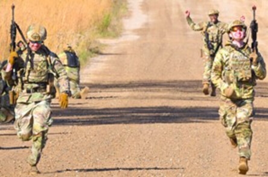 U.S. Air Force Staff Sgt. Brandon Hall, 891st Missile Security Forces Squadron (MSFS) unit program coordinator, runs formation drills during Operation Cerberus at Camp Ripley, Minnesota, Sept. 23, 2024. The 891 MSFS executed training in a variety of disciplines including land navigation, tactical combat casualty care, close quarters battle tactics and conventional weapons training.
