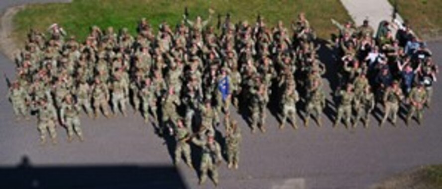 Airmen assigned to the 891st Missile Security Forces Squadron pose for a group photo at Camp Ripley, Minnesota, Sept. 26, 2024. Camp Ripley is a 53,000-acre training center with numerous ranges and facilities designed for military and civilian agencies to develop their skills.