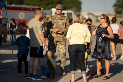 Military person speaking to people outside.