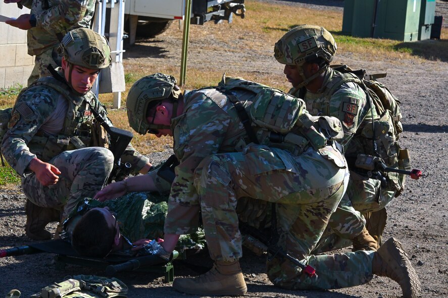 Airmen assigned to the 891st Missile Security Forces Squadron perform simulated tactical combat casualty care (TCCC) on their wingman during Operation Cerberus at Camp Ripley, Minnesota, Sept. 24, 2024. TCCC severely reduces the risk of hemorrhaging, which is the leading preventable cause of death in combat.