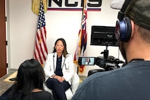 Deputy Director of Operational Support Elizabeth Pierri speaks to a Honolulu-based investigative reporter Aug. 28, 2024, to discuss the cold case investigation into the 1980 murders of Marine Corps Lance Cpl. Lawrence Martens and Lance Cpl. Rodney Padilla.