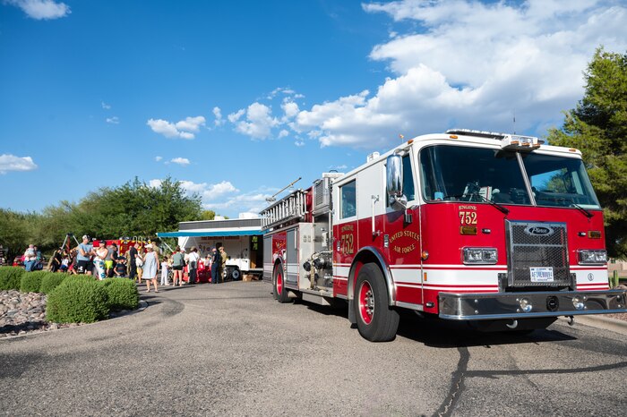 Members of the Davis-Monthan community connect with installation firefighters ahead of Fire Prevention Week at Davis-Monthan Air Force Base, Arizona, Oct. 1, 2024. The 2024 campaign was focused on educating people about the importance of maintaining functional smoke alarms. (U.S. Air Force photo by Airman 1st Class Jasmyne Bridgers-Matos)