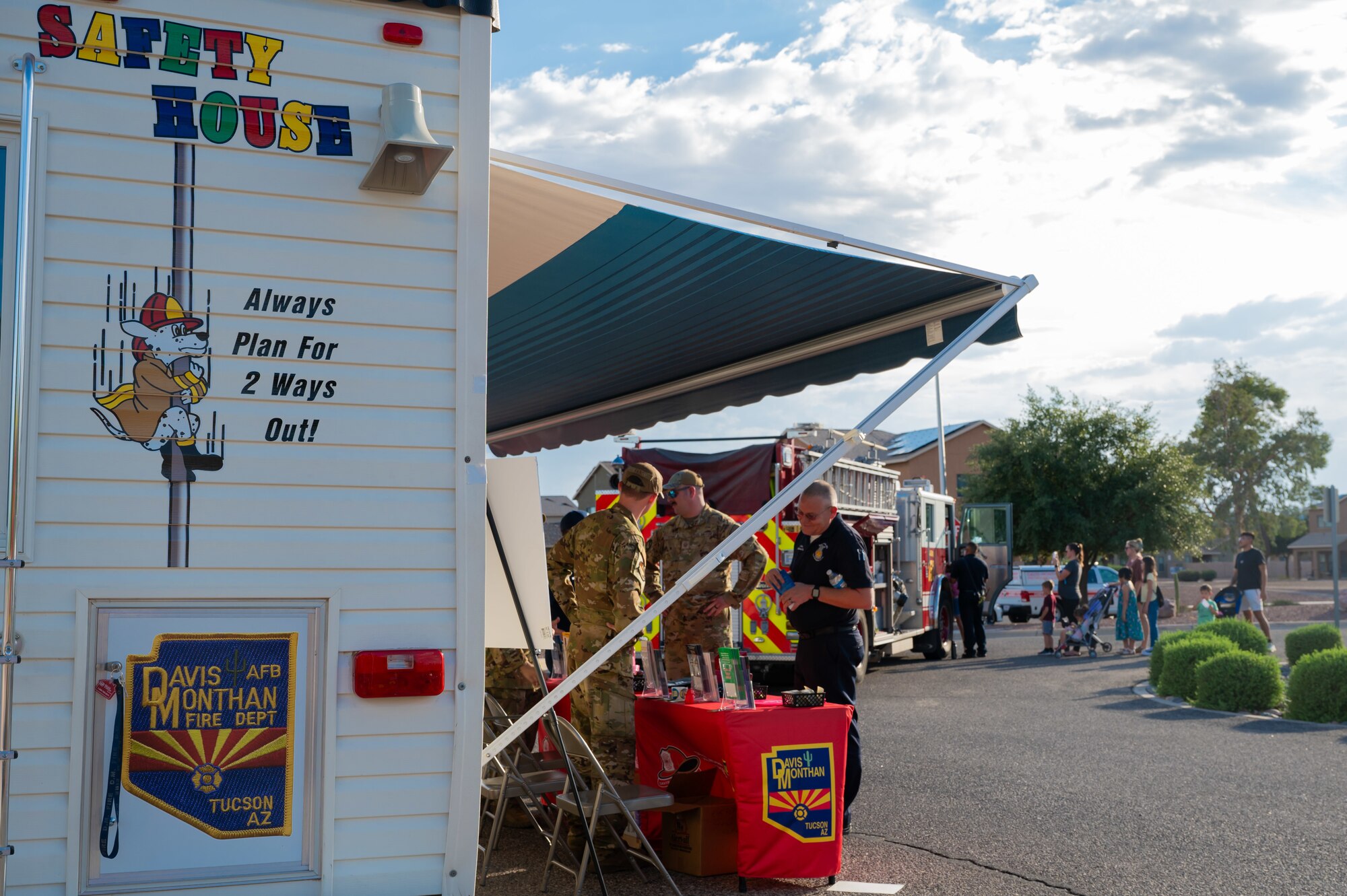 U.S. Air Force 355th Civil Engineer Squadron firefighters engage with members of the community at Davis-Monthan Air Force Base, Arizona, Oct. 1, 2024. Installation firefighters set up static displays, gave out merchandise, and provided activities to educate people on fire safety. (U.S. Air Force photo by Airman 1st Class Jasmyne Bridgers-Matos)