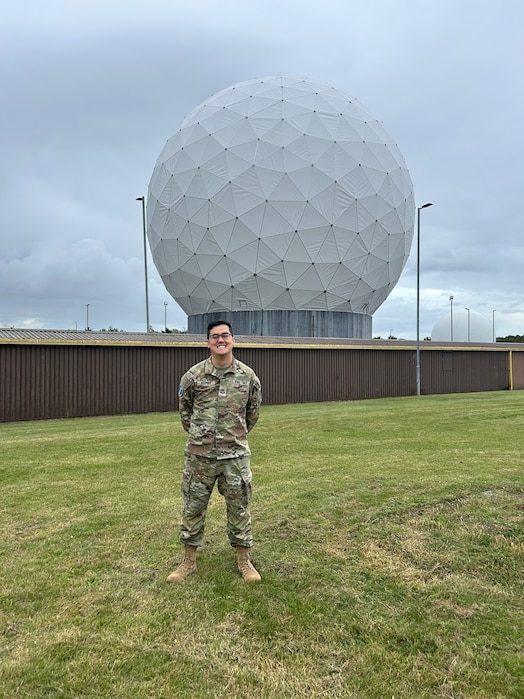  Sgt. Ty Norman poses for a photo near a radome at Royal Air Force Feltwell, United Kingdom.