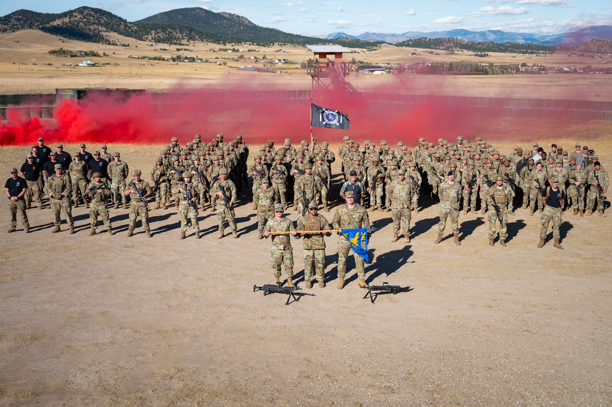 A group of uniformed personnel stand together.