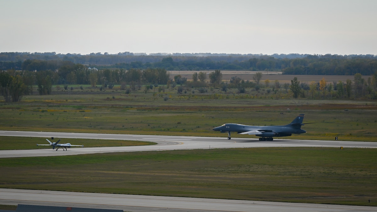 Two aircrafts stand on a runway.