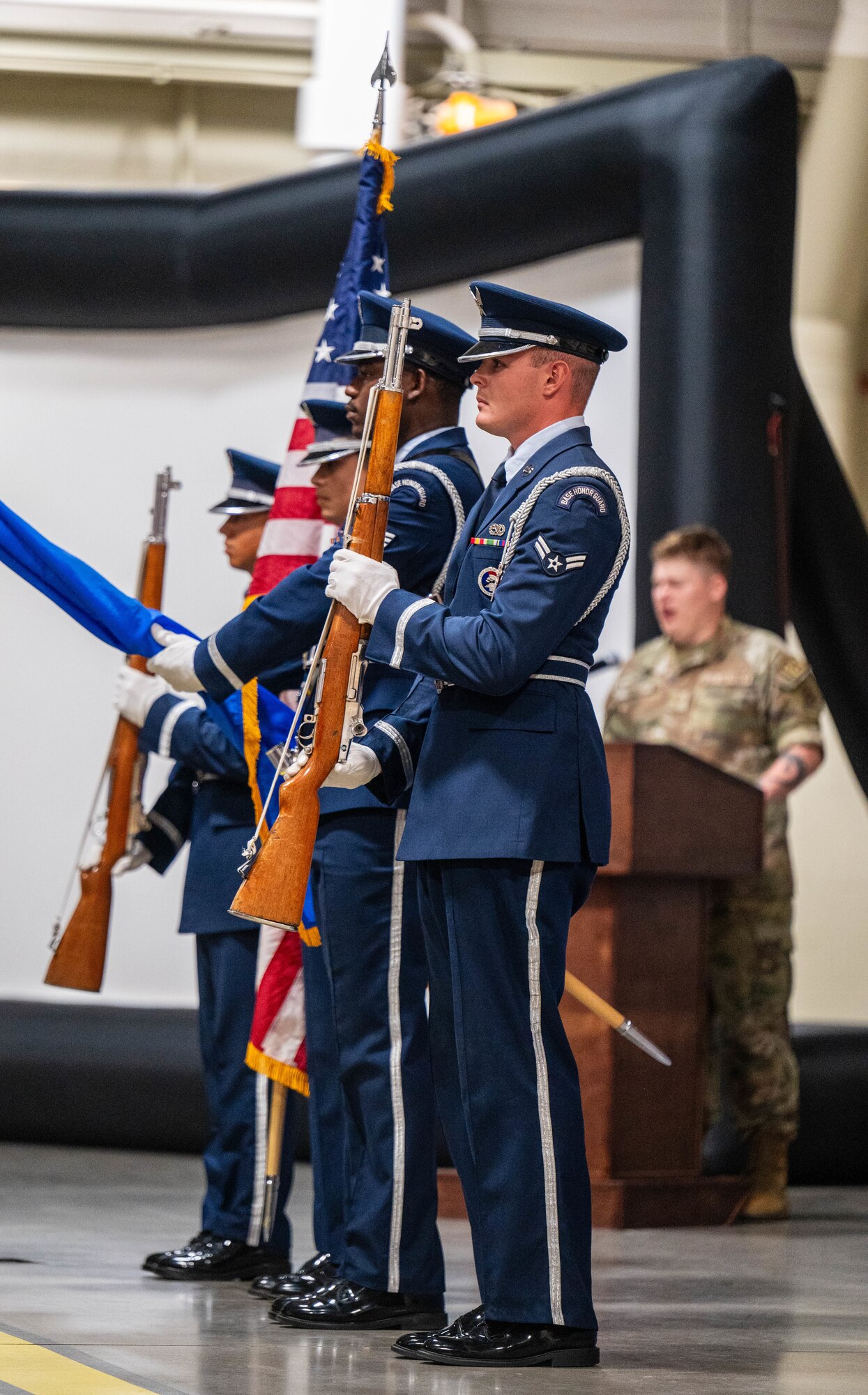 U.S. Air Force Honor Guardsmen assigned to the 56th Fighter Wing present the colors as Staff Sgt. David Busby (back-right), 56th FW community relations noncommissioned officer in-charge, sings the National Anthem during the 2024 Honorary Commander induction ceremony, Sept. 26, at Luke Air Force Base, Arizona.
