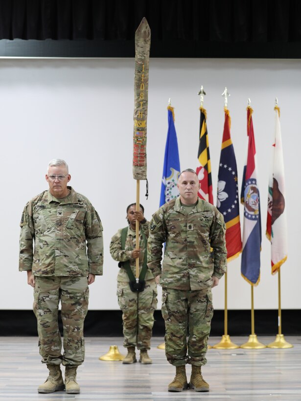 The outgoing command team of the 1108th Theater Aviation Sustainment Maintenance Group prepare to case their unit colors to mark the official end of their tour in theater during a transfer of authority ceremony in the U.S. Central Command area of responsibility, Aug. 14, 2024. (U.S. Army photo by Sgt. 1st Class Gecyca Martin)