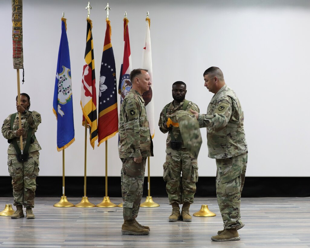 The command team of the 1100th Theater Aviation Sustainment Maintenance Group uncase their home unit colors to mark the official start of their tour in theater during a transfer of authority ceremony in the U.S. Central Command area of responsibility, Aug. 14, 2024. (U.S. Army photo by Sgt. 1st Class Gecyca Martin)