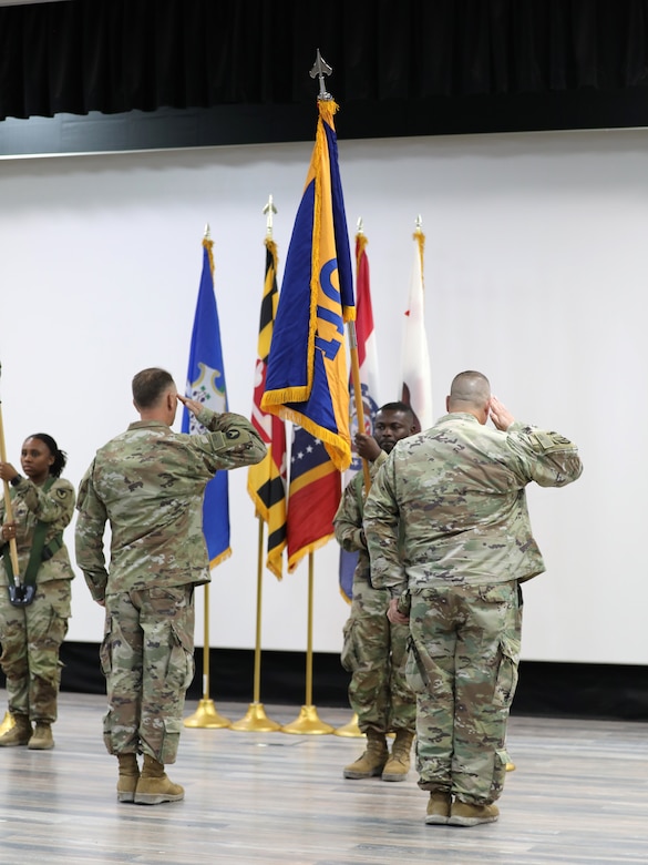 The command team of the 1100th Theater Aviation Sustainment Maintenance Group uncase their home unit colors to mark the official start of their tour in theater during a transfer of authority ceremony in the U.S. Central Command area of responsibility, Aug. 14, 2024. (U.S. Army photo by Sgt. 1st Class Gecyca Martin)