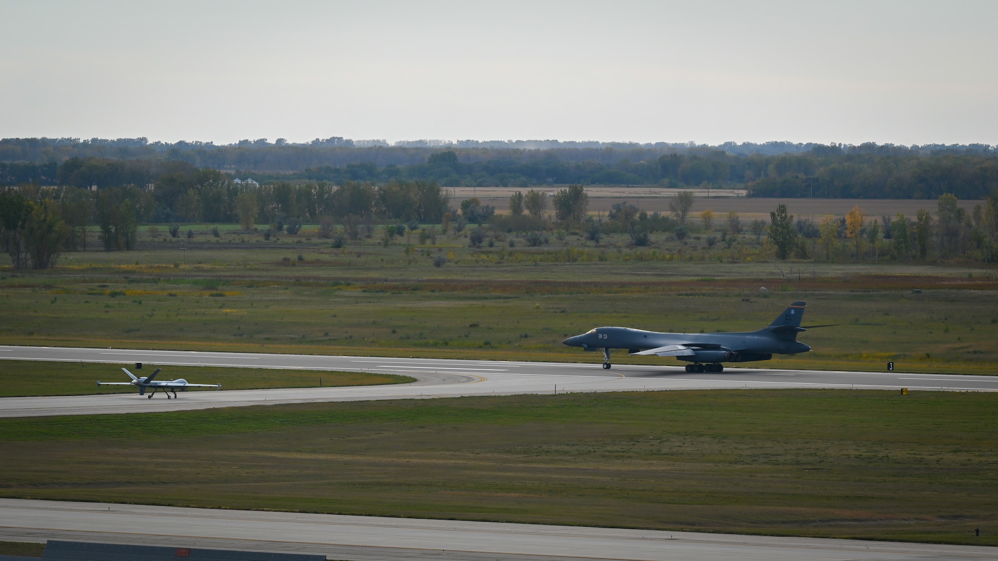 Two aircrafts stand on a runway.