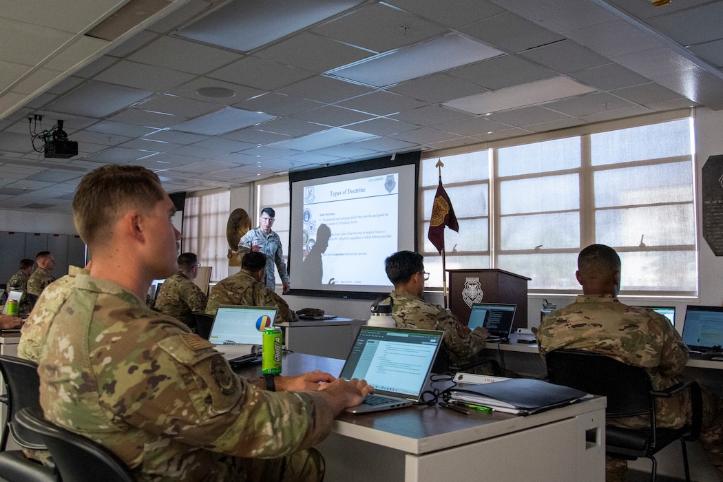 Side view of instructor while students look on.