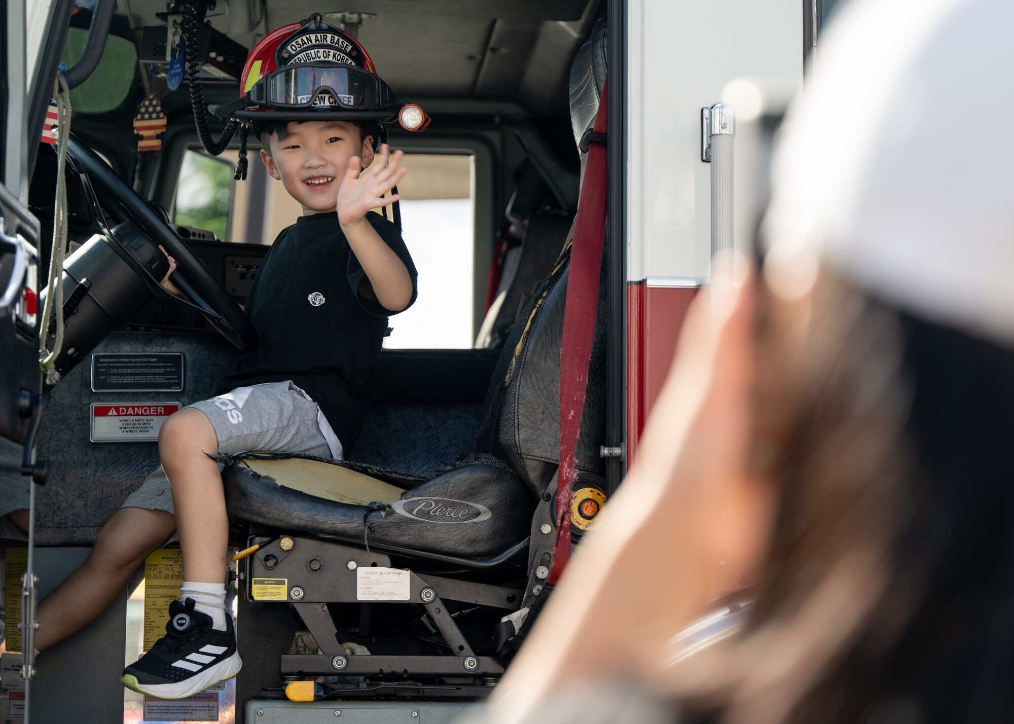 A Korean child poses for a photo for his family in a U.S. Air Force fire engine assigned to the 51st Civil Engineer Squadron during the 21st annual Republic of Korea and U.S. Cultural Festival outside Osan Air Base, ROK, Sept. 28, 2024. The festival, held just outside of the installation, allowed local community members to participate in cultural events designed to build better relationships and understanding between the two nations. (U.S. Air Force photo by Maj. Kippun Sumner)