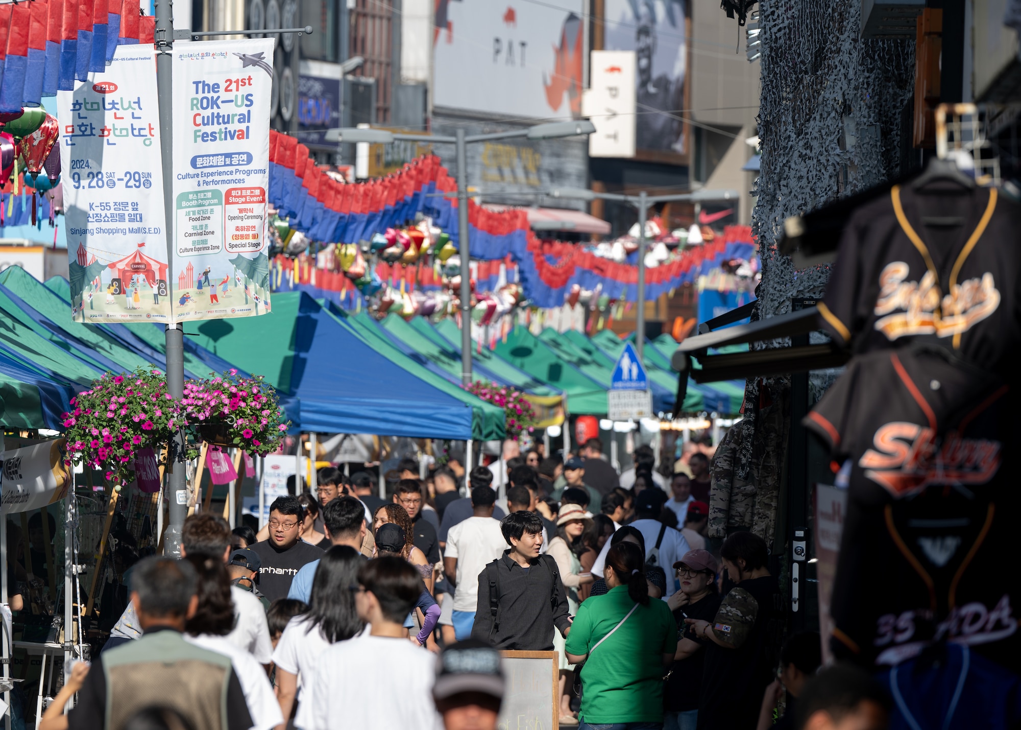 Korean and American local community members peruse event booths during the 21st annual Republic of Korea and U.S. Cultural Festival, held outside of Osan Air Base, ROK, Sept. 28, 2024. The festival featured a variety of booths and displays from both South Korean and Osan AB communities that worked to build better relationships between the base and its surrounding communities. (U.S. Air Force photo by Maj. Kippun Sumner)