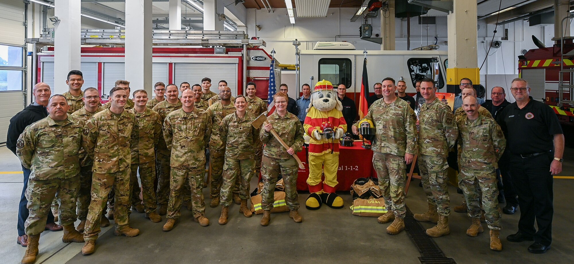 Firefighters and base leadership stand together for a group photo.