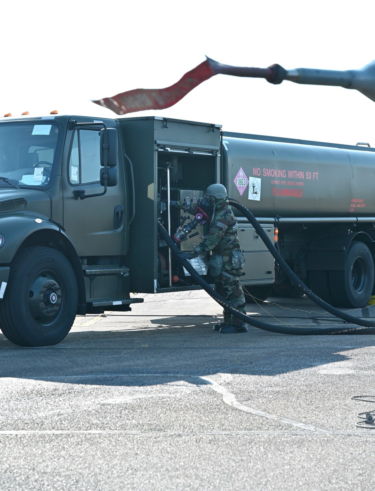 U.S. Air Force Senior Airman Jovon Green, 100th Logistics Readiness Squadron Petroleum, Oils and Lubricants fuels facilities technician, returns a fuel hose onto an R-11 refueling truck after refueling an F-16 Fighting Falcon assigned to Aviano Air Base, Italy, at Royal Air Force Mildenhall, England, Sept. 19, 2024. RAF Mildenhall is currently hosting the aircraft for Cobra Warrior – a U.K. RAF-sponsored exercise – and chose to test their chemical, biological, radiological and nuclear support capabilities for the multi-lateral, live-fly field-training exercise. (U.S. Air Force photo by Karen Abeyasekere)