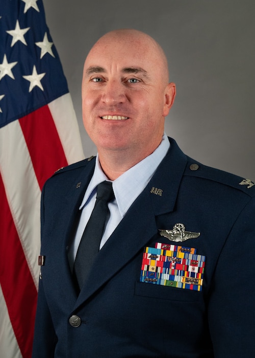 A man takes his Air Force official photo.