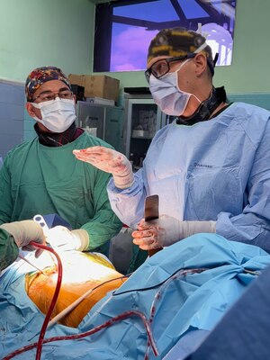 A Honduran orthopedic resident and Lt. Cmdr. John Richards, an orthopedic trauma surgeon assigned to Expeditionary Medical Facility (EMF) Kilo, provides education and surgical techniques during a complex poly trauma surgery of the pelvis and humerus in the operating room at Hospital Escuela, Tegucigalpa, Honduras, Sep. 18, 2024. In collaboration with joint forces and the partner nation, EMF Kilo conducted its first orthopedic surgical mission alongside Hospital Escuela medical staff treating and performing surgical procedures on patients with oncologic or orthopedic traumatic injuries. (U.S. Navy photo by Lt. Cmdr. Sheree Blackwell)