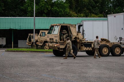 U.S. Army Soldiers assigned to the LaGrange-based 1177th Transportation Company, 265th Chemical Battalion, 201st Regional Support Group, Georgia Army National Guard, prepare heavy expanded mobility tactical trucks (HEMTT) to deliver supplies to those affected by Hurricane Helene, Oct. 1, 2024, at the Macon State Farmer’s Market in Macon, Georgia.