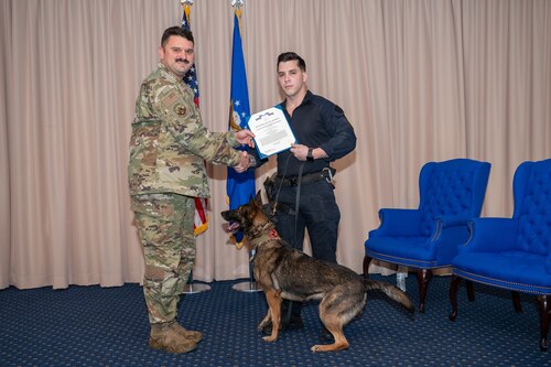 Image of men and a dog