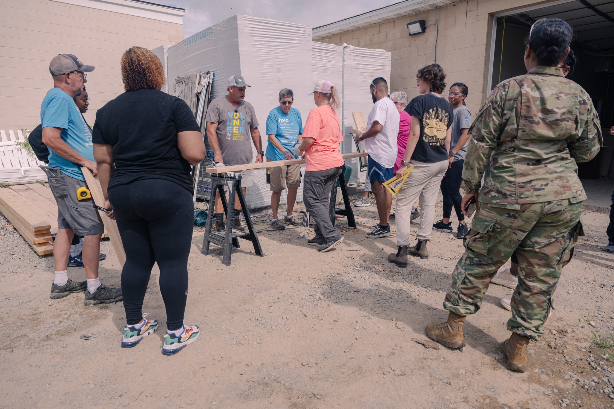 A group of people stand around tools.