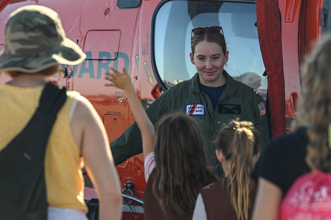 Girls in Aviation participants raise their hands for a member of the U.S. Coast Guard in Oakland, California, Sept. 28, 2024. Through interactive workshops and engaging presentations, participants discovered the diverse career paths available to them, ranging from piloting and engineering to air traffic control and aviation management.