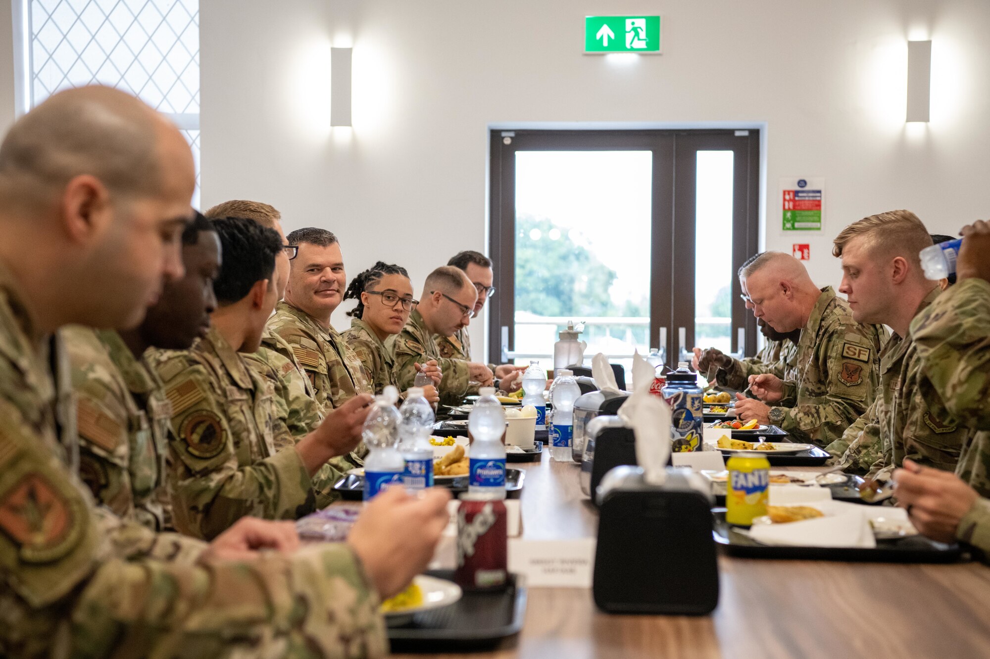 The director of Security Forces speaks with Defenders during a luncheon