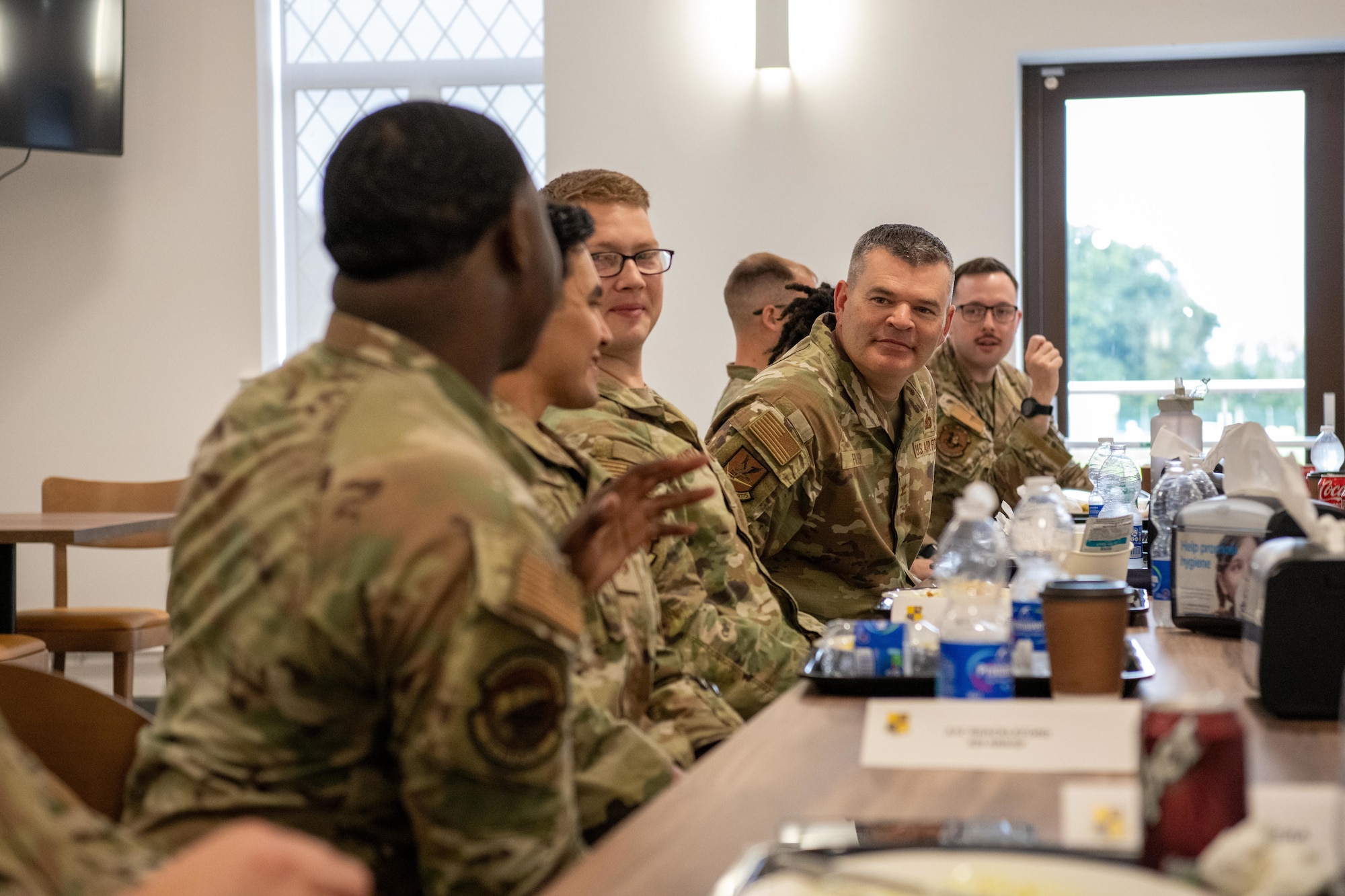 The director of Security Forces speaks with Defenders during a luncheon