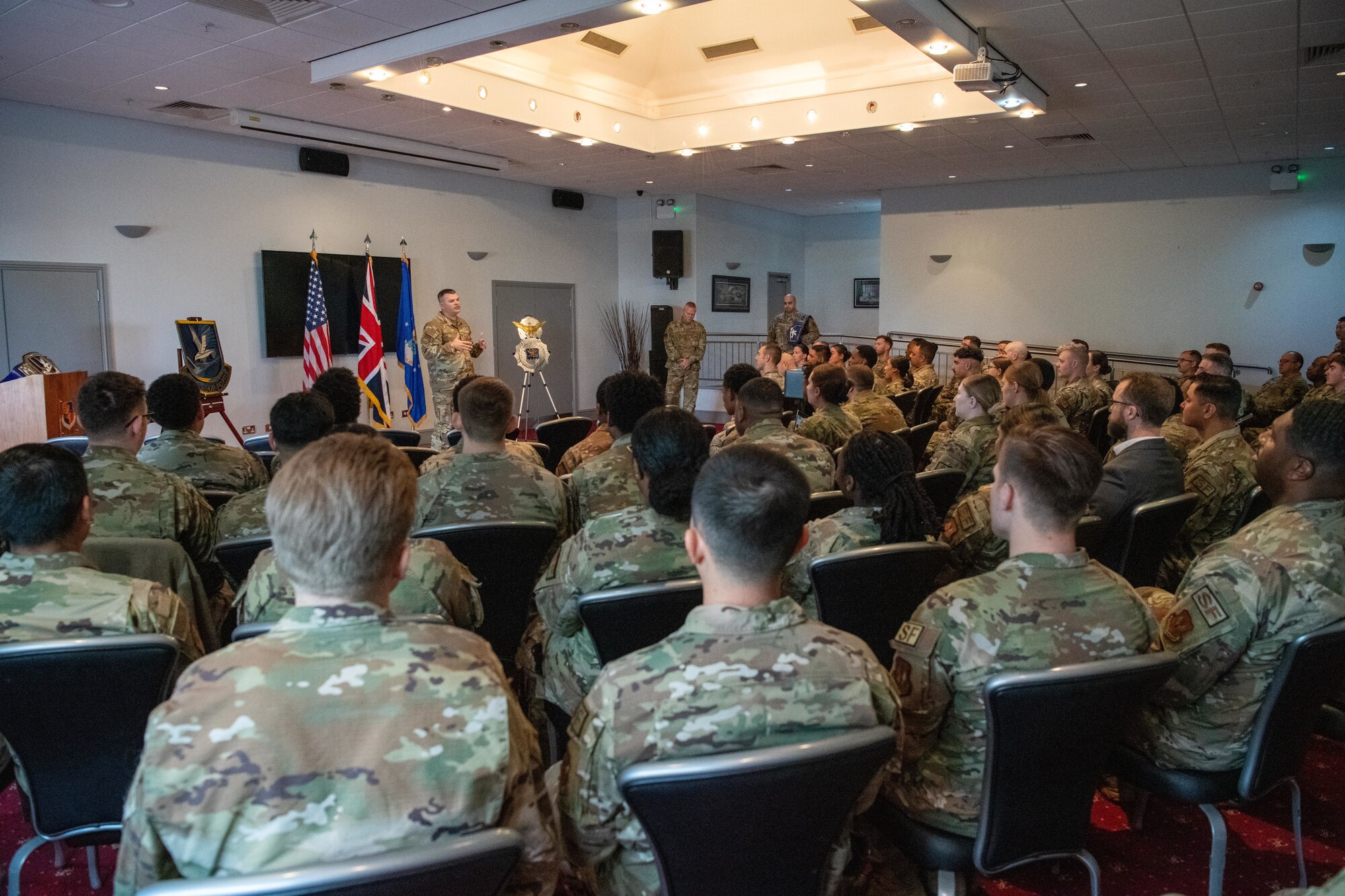 The director of Security Forces gives remarks during an all call