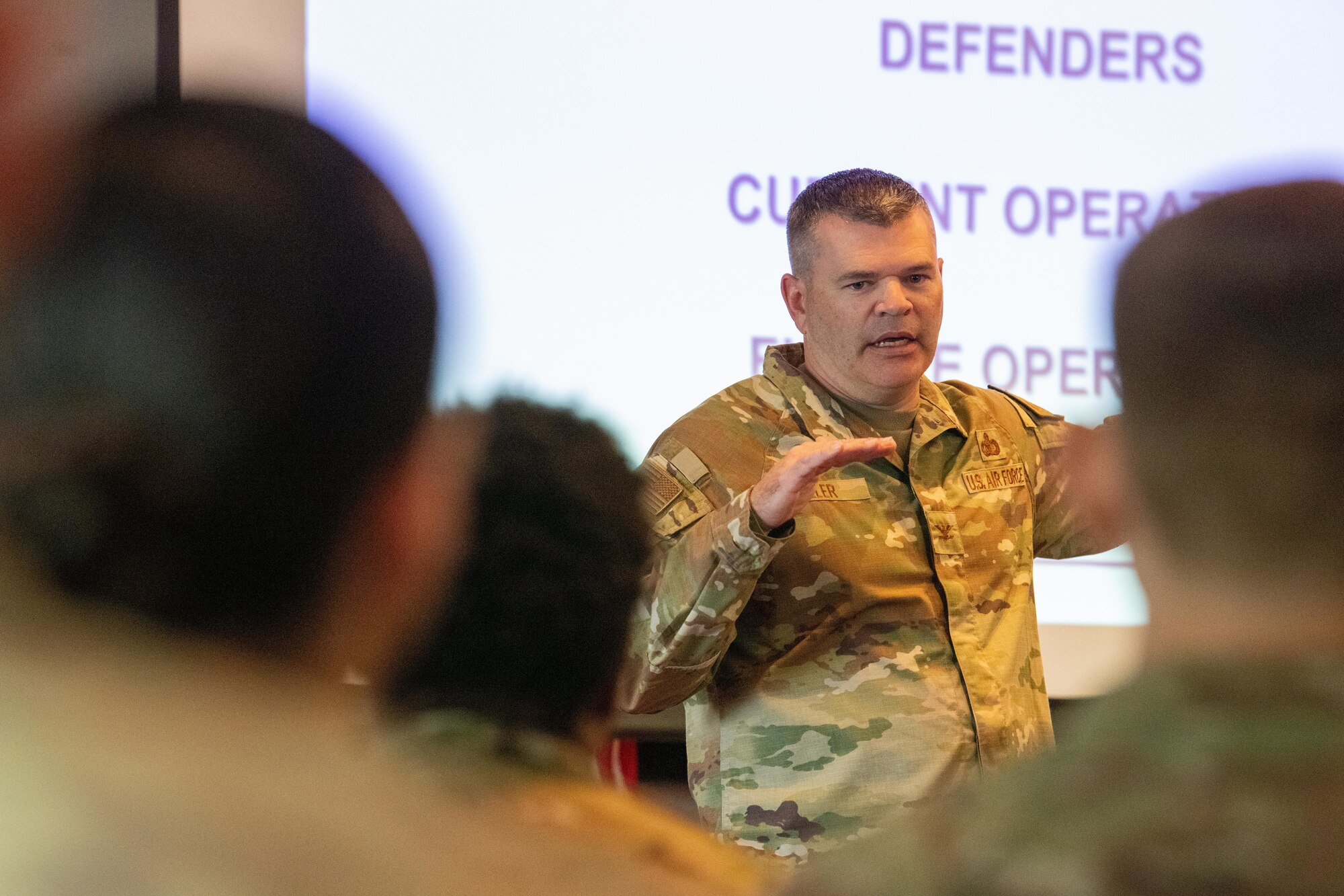 The director of Security Forces gives remarks during an all call