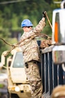 U.S. Air National Guard Master Sgt. Jordan Hackworth, a heating, ventilation, air conditioning and refrigeration craftsman with the 134th Civil Engineer Squadron, assists with debris clearing near a supplies distribution location in Johnson City, Tenn., Oct. 2, 2024.
