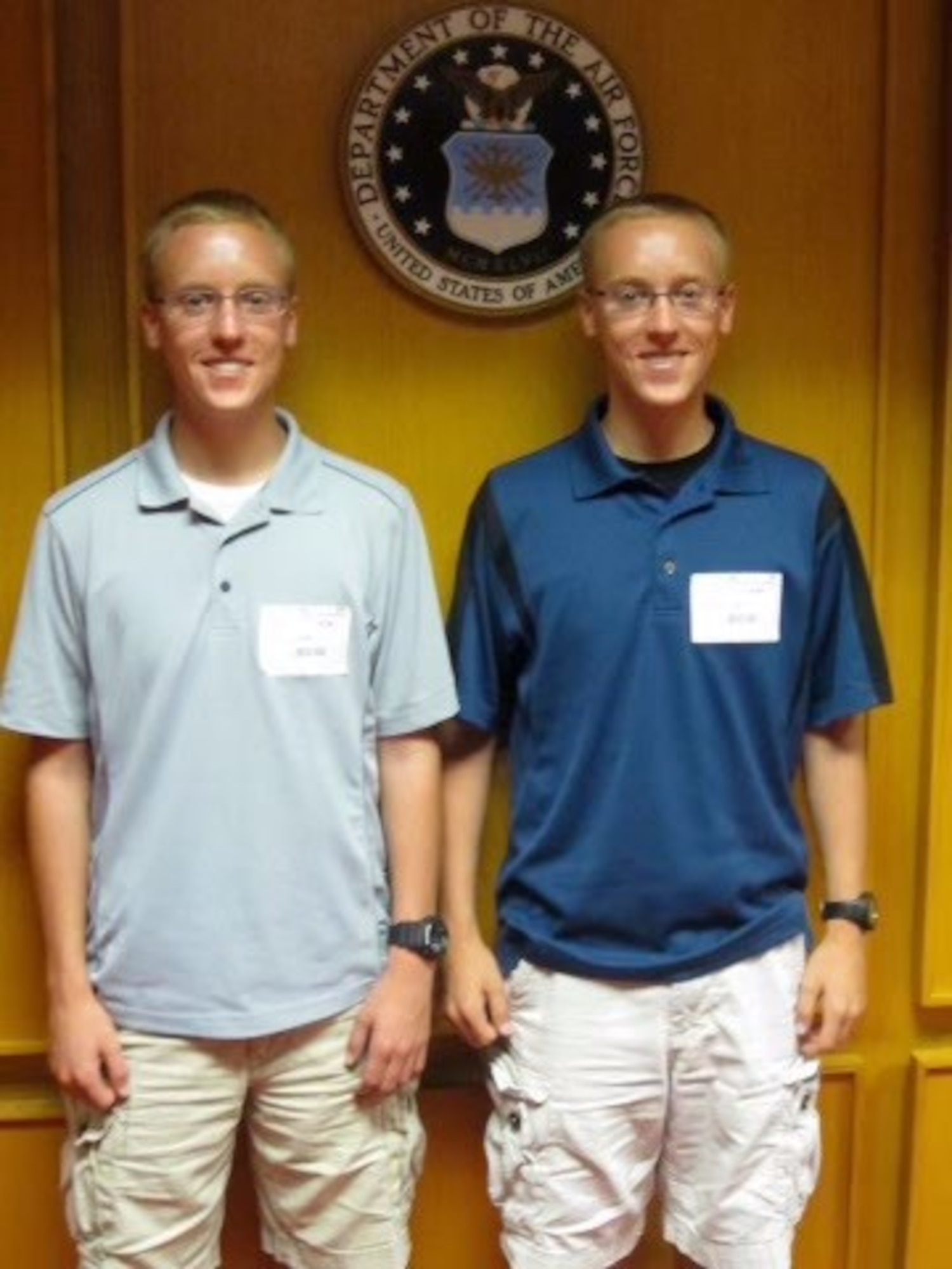 Charles Platt (left) and Christopher Platt stand together at a Military Entrance Processing Station, Sept. 3, 2012. The identical twins pursued a career in the Air Force together – from enlisting together to completing Basic Military together – until now, where both are assigned to the 737thTraining Group. The brothers share more than similar looks, they also share a goal of inspiring young Airmen. (Courtesy photo)