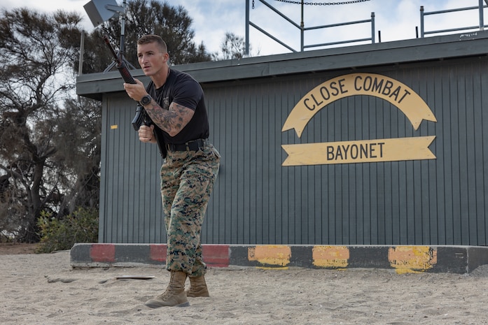 U.S. Marine Corps Martial Arts Instructor, Staff Sgt. Jacob Sinclair, with Support Battalion, Recruit Training Regiment, demonstrates the modified basic warrior stance bayonet technique to recruits with Kilo Company, 3rd Recruit Training Battalion at Marine Corps Recruit Depot San Diego, California, Sept. 25, 2024. Bayonet techniques tie into the Marine Corps Martial Arts Program and strengthens the mental and moral resiliency of individual recruits and Marines through realistic combative training, warrior ethos studies, and physical hardening. (U.S. Marine Corps photo by Lance Cpl. Janell B. Alvarez)