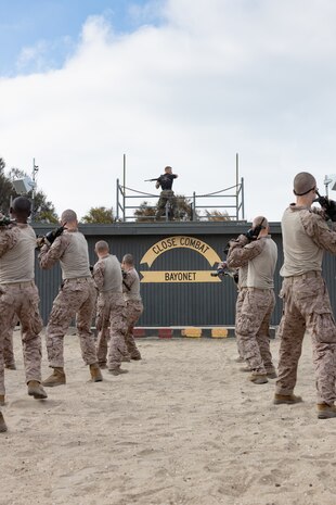 U.S. Marine Corps Martial Arts Instructor, Staff Sgt. Jacob Sinclair, with Support Battalion, Recruit Training Regiment, demonstrates a horizontal buttstroke bayonet technique to recruits with Kilo Company, 3rd Recruit Training Battalion at Marine Corps Recruit Depot San Diego, California, Sept. 25, 2024. Bayonet techniques tie into the Marine Corps Martial Arts Program and strengthens the mental and moral resiliency of individual recruits and Marines through realistic combative training, warrior ethos studies, and physical hardening. (U.S. Marine Corps photo by Lance Cpl. Janell B. Alvarez)