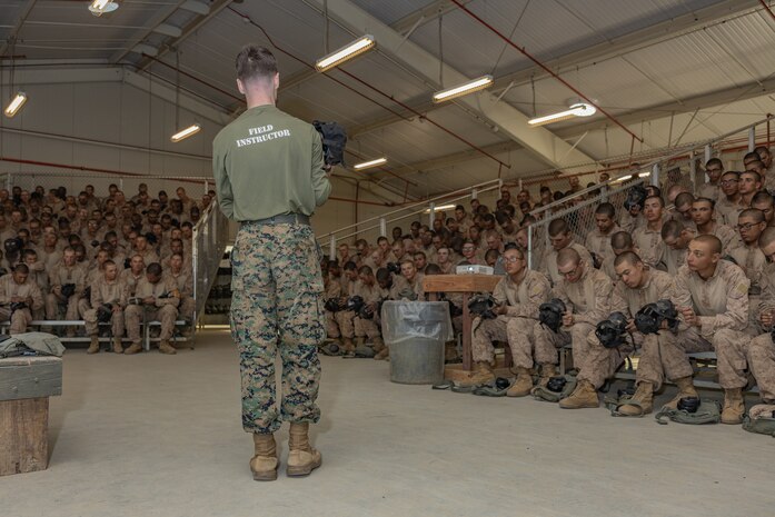 U.S. Marine Corps Lance Cpl. Cavan Womack, a chemical, biological, radiological and nuclear defense specialist, with Weapons Field Training Battalion, teaches recruits with Echo Company, 2nd Recruit Training Battalion, during a confidence chamber class at Marine Corps Base Camp Pendleton, California, Sept. 26, 2024. The confidence chamber trained recruits on how to properly use the M50 gas mask, respond to potential chemical and biological threats, and to have trust and confidence in their issued gear.  (U.S. Marine Corps photo by Lance Cpl. Janell B. Alvarez)