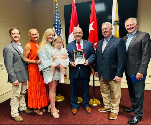 Photo of group standing with award recipient