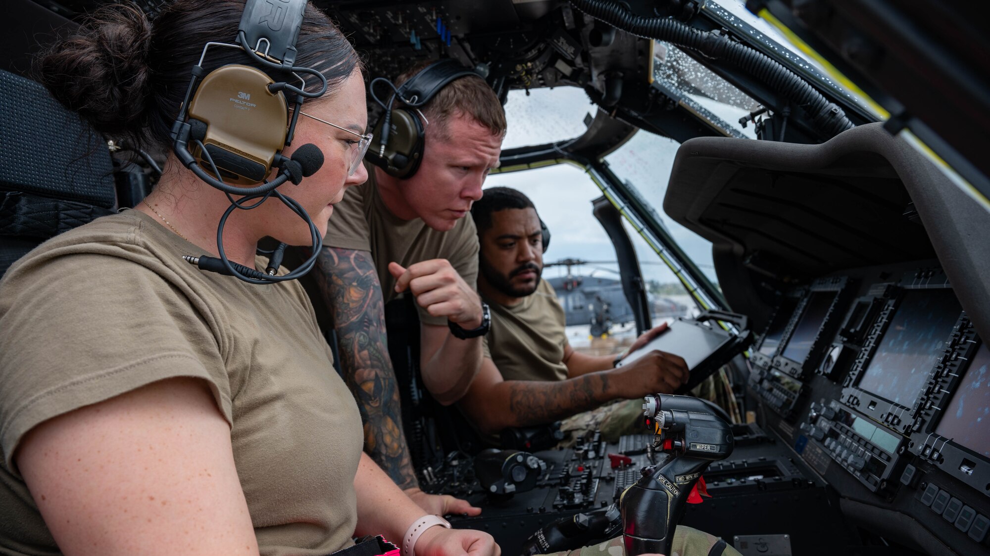 U.S. Air Force Tech Sgt. Douglas Wheeler instructs Airmen from the 721st on the equipment in a HH-60W
