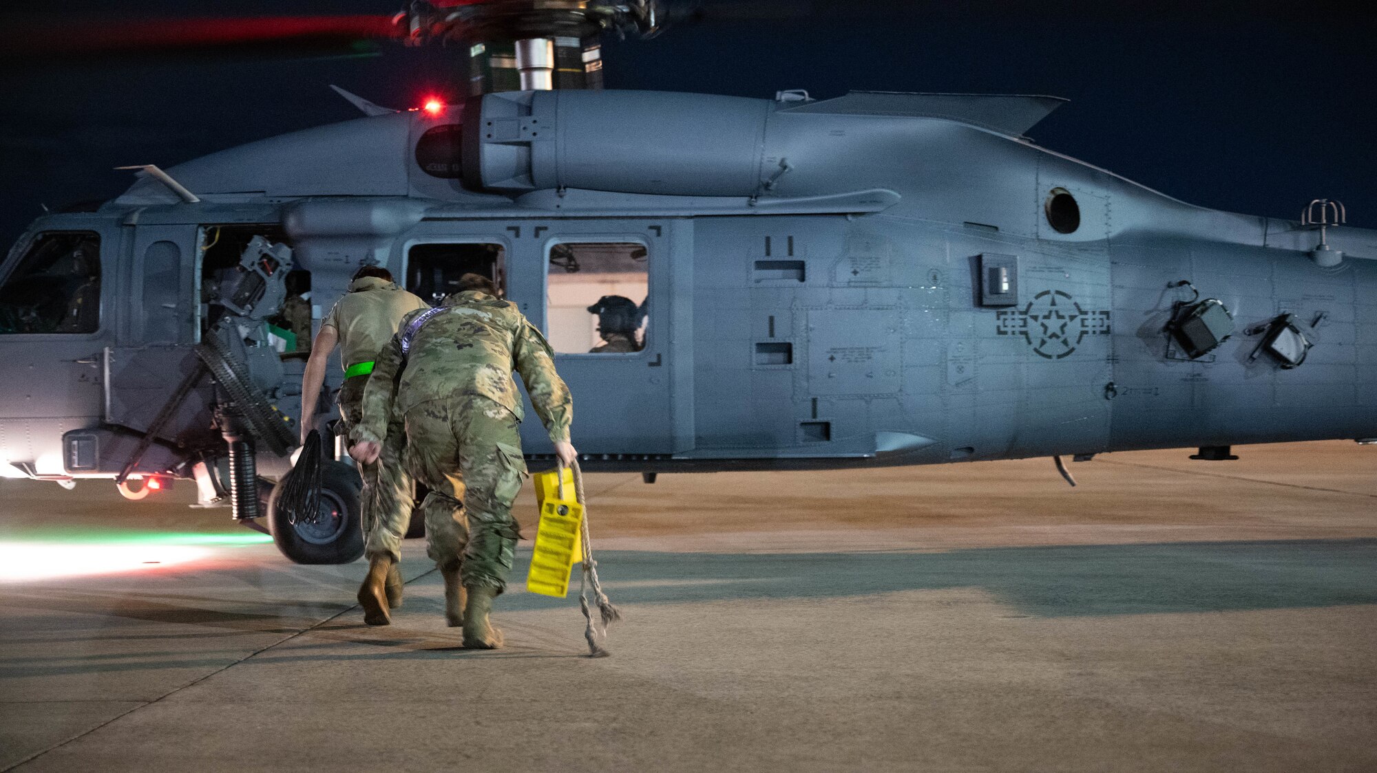 Airmen from the 721st bring chals to a HH-60W