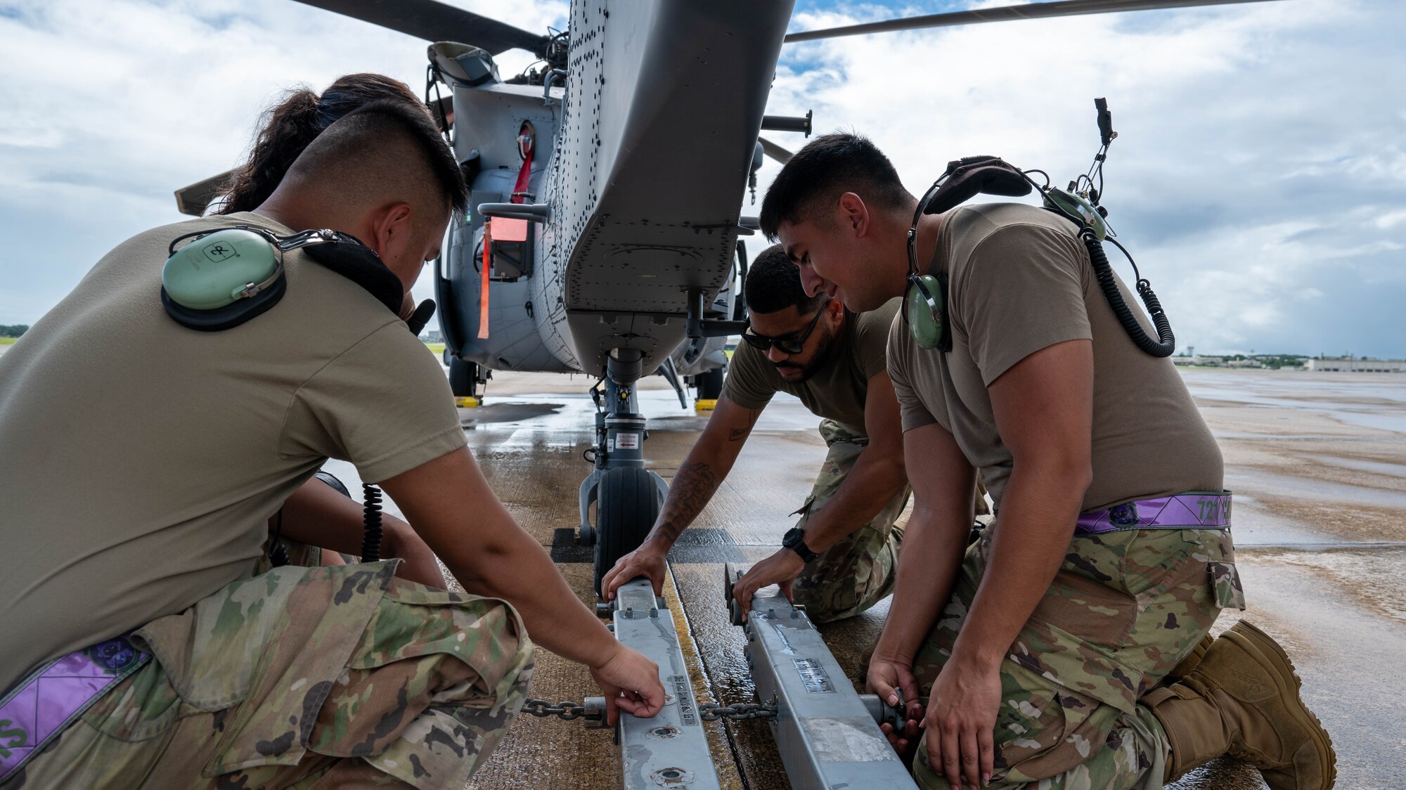 Airmen from the 721st hook on a towning cabel